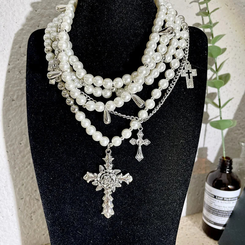 Pearl beaded necklaces are layered with men's and women's sweaters