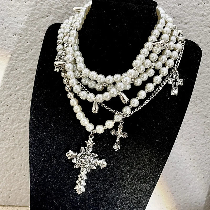 Pearl beaded necklaces are layered with men's and women's sweaters